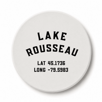 Round white ceramic coaster with Lake Rousseau lettering and latitude and longitude coordinates