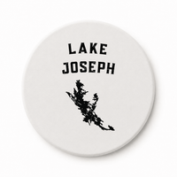 Round white ceramic coaster with Lake Joseph lettering and black lake silhouette
