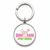 Round Mahjong keychain that says Bird Bam spirit animal with a pink bird