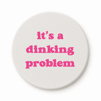 Round ceramic pickleball coaster that says its a dinking problem in pink