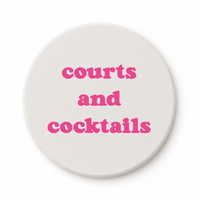 Round ceramic pickleball coaster that says courts and cocktails in pink