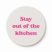 Round ceramic pickleball coaster that says stay out of the kitchen in pink
