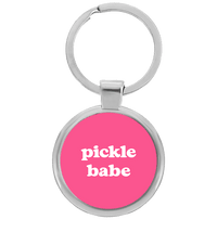 Round silver pickleball keychain with pink pickle babe design