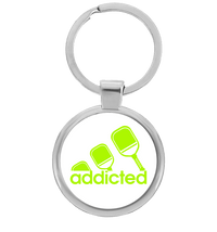 Round pickleball keychain with neon green addicted paddle design